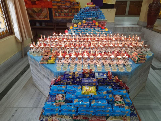 Butter lamps and tiered offerings arranged on a shrine at Sed Gyued Monastery