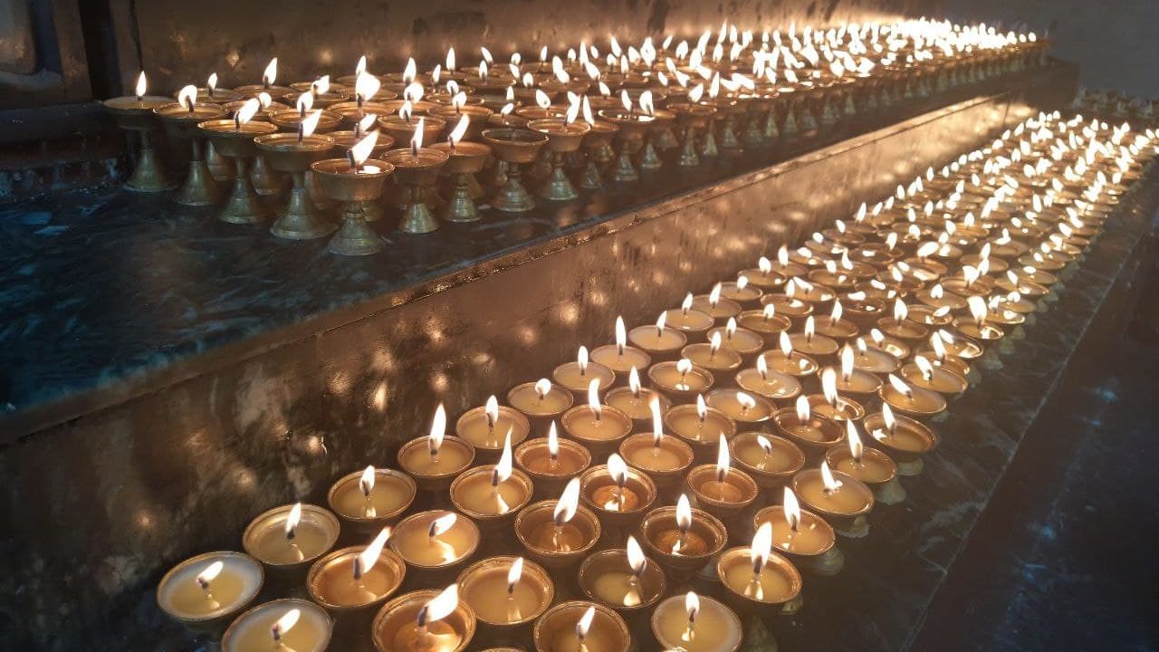 Rows of butter lamps lit in offering at Sed Gyued Monastery