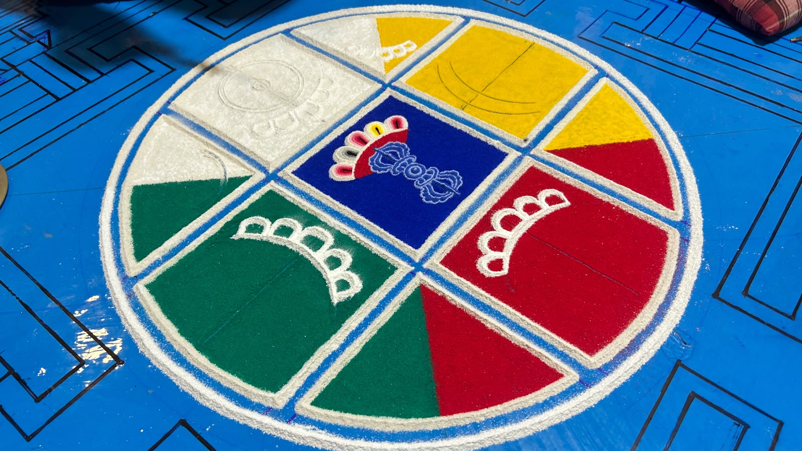 Monks laying the coloured sand of the Vajrabhairava mandala at Sed Gyued Monastery, 2026